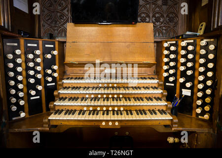 Orgel (Musikinstrument) und seiner Tasten/Tastatur in Halifax Minster. Die Orgel Haltestellen sind auf beiden Seiten sichtbar. West Yorkshire. UK. Es wurde von Harrison und Harrison von Durham, UK Stockfoto