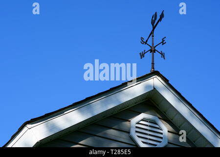 Die vier Himmelsrichtung auf der Spitze einer Scheune mit blauen Himmel. Stockfoto