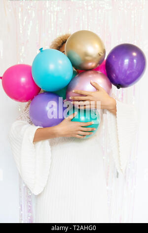 Junge Frau Holding Ballons Stockfoto