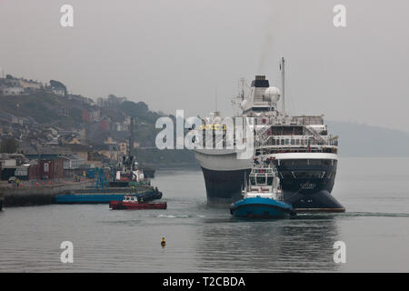 Cobh, Cork, Irland. Der 1. April 2019. Erste liner der neuen Saison Kreuzfahrt Astoria von der Tug Boat Gerry O'Sullivan in Cobh, Co Cork, Irland manövriert wird. Quelle: David Creedon/Alamy leben Nachrichten Stockfoto