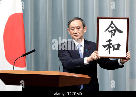 Tokio, Japan. 01 Apr, 2019. Japan's Chief Cabinet Secretary Yoshihide Suga hält aloft ein gerahmtes Bild von 'Reiwa', der Name des neuen Japan ära, während einer Pressekonferenz in Tokyo, Japan, April 1, 2019. Die japanische Regierung verkündete Montag, 'Reiwa' wird der Name des neuen Japan Ära werden am 1. Mai, als Kronprinz Naruhito steigt die Chrysantheme Thron die Nachfolge seines Vaters Kaiser Akihito zu starten. Quelle: Xinhua/Alamy leben Nachrichten Stockfoto