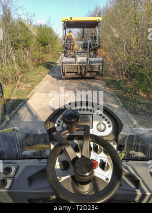 Kladovo, Serbien - April 01, 2019: Der Ausblick vom Asphalt aufstieg Walze vor Es ist sichtbar an die Heftstation. Gemeinsam bewegen Sie sich auf den Asphalt. Stockfoto