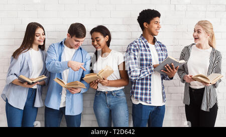 Learning Konzepts. Jugendliche mit Büchern in der Nähe von Light Wall, Vorbereitung auf Prüfungen Stockfoto