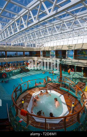 Personen, die das innere Schwimmbad auf dem Kreuzfahrtschiff MSC Splendida Stockfoto