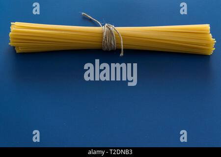 Isolierte trockene Spaghetti auf blauem Hintergrund Stockfoto