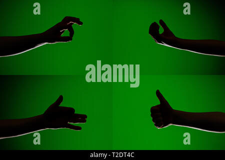 Ein Satz von Zeichen auf die Finger der Hände, die Silhouetten auf einem isolierten grünen Hintergrund 2019 dargestellt Stockfoto