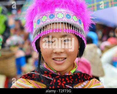 Junge vietnamesische Blume H'mong Frau trägt die farbenfrohe Tracht und Kopfschmuck der Blume H'mong Menschen. Stockfoto