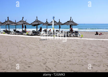 Fuengirola, Costa del Sol, Spanien. März 25, 2019. Urlauber genießen die Sonne auf einer mediterranen Strand bei Fuengerola an der Costa del Sol. Stockfoto