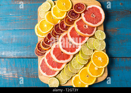 Gesunde Ernährung Konzept. Muster mit frischen Schichten verschiedener Zitrusfrüchte - Gelb und Rot Orange, Limette, Zitrone und Grapefruit. Flach, kopieren. Stockfoto