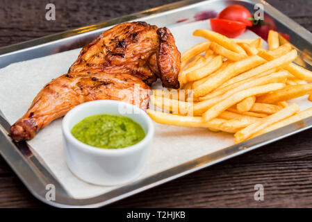 Schließen Sie das Fach mit grossen Mahlzeit mit gebratenen Hähnchen Schenkel. Selektiver Fokus Stockfoto