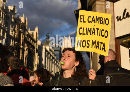 Eine Frau gesehen, die ein Schild lesen "Klimawandel uns tötet" Während des Protestes. Aktivisten aus der Gruppe Aussterben Rebellion versammelten sich in Callao Square in Madrid spanische Regierung Maßnahmen gegen den Klimawandel zu fordern. Stockfoto