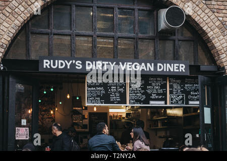 London, UK - März 23,2019: Die Menschen essen Bestellen von Rudy's Dirty Vegan Diner in Camden Market. Mit 16 Ständen im Jahr 1974 gestartet, Camden Market ist Stockfoto