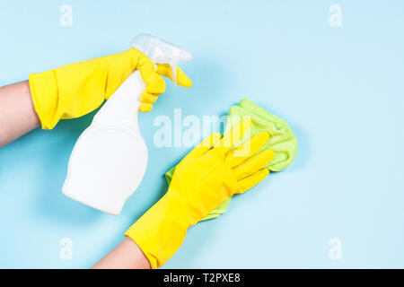 Frau Reinigung blaue Wand Microfaser mit rag und Reinigungsspray Agent. Stockfoto