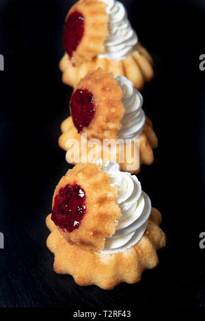Rum baba mit Schlagsahne und comfiture oder Marmelade Stockfoto
