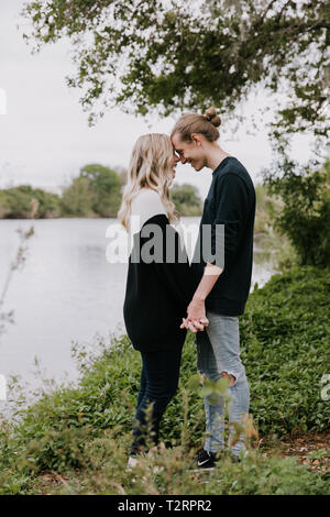 Junge romantische Paar hält jede Andere für Paare Portraits von den Teich draussen in der Natur Stockfoto