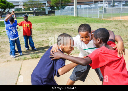 Miami Florida, Moore Park, Touch Fußball Huddle, Sport, Spiel, Strategie, hispanische Schwarzafrikanische Afrikaner, junge Jungen männliche Kinder Jungen, Kind, Student Stud Stockfoto