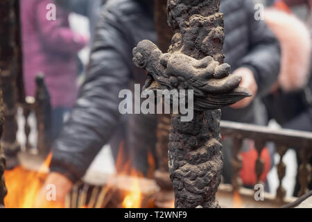 Nahaufnahme eines Altars mit Drachen, Carving, Räuchergefäß, Joss Topf, Räucherstäbchen brennen mit raucht in einem buddhistischen Tempel Stockfoto