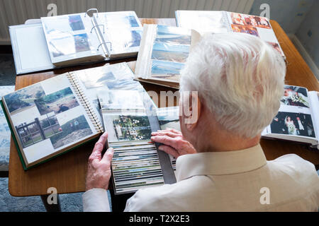 Blick von oben auf ein älterer Mann in alten Fotoalben Stockfoto