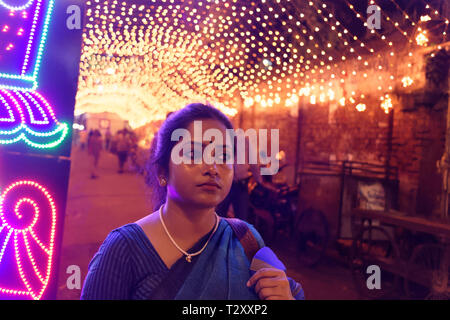 Indische Bengali Dame auf der Straße voller Lichter in einem festlichen Abend Stockfoto