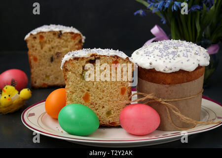 Ostern Kuchen und bunte Eier auf einer Platte auf einem dunklen Hintergrund befinden, horizontale Foto Stockfoto