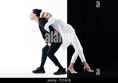 Modelle posieren. Zwei junge gut aussehende Modelle in der Nähe von weißen und schwarzen Hintergrund posiert zusammen Stockfoto