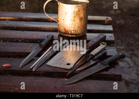 Rostige Messer auf Holzpalette, Bauer Geräte in Kuba, Fleisch Cleaver mit Fleischermesser, Set alte Schlächter Messer, Schlachtung ein ganzes Schwein Stockfoto