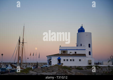 Seaward Eingang in den Hafen von Duquesa (Puerto De La Duquesa). Bild in der Abenddämmerung mit einem Horizont steigenden Ernte Vollmond erfasst Stockfoto