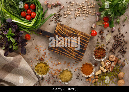 Frischem Gemüse und Tomaten Gewürze Getreide und Nüsse Bio gesunde Snacks auf einer strukturellen Hintergrund. Konzept der gesunden Ernährung. Rahmen unter dem Text. Stockfoto