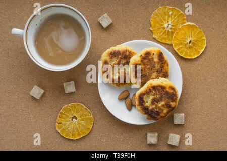 Käsekuchen mit einer Tasse Kaffee. Flach. Die Aussicht von oben. Frühstück. Stockfoto