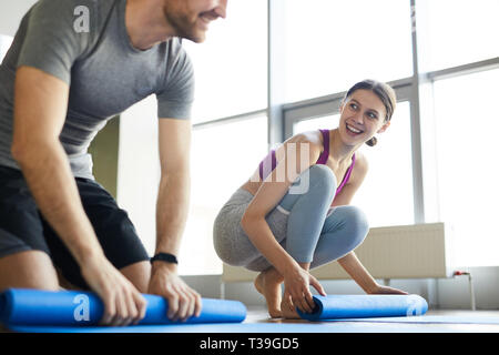 Neugierige junge Leute plaudern nach Yoga Ausbildung Stockfoto