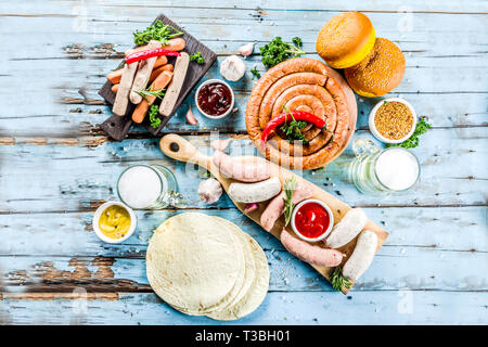 Verschiedene BBQ-Picknick Party Food mit Bier Verschiedene gegrillte Würstchen, burger Buns, Flachbild taco Brot, Bier, alte hölzerne Background Copy space Stockfoto