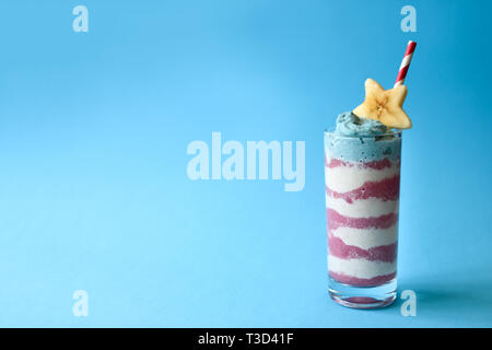 Patriotische smoothie Brille mit blauem Spirulina, Erdbeere und Vanille Smoothies auf blauem Hintergrund Stockfoto