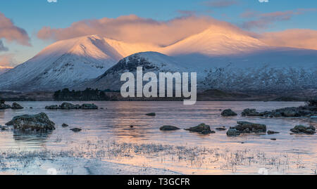 Sonnenaufgang über einen gefrorenen Lochan na h-achlaise auf Rannoch Moor in der Nähe der Eingang zu Glencoe in die schottischen Highlands Stockfoto