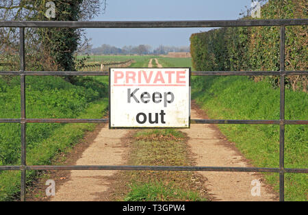 Ein eigenes Zeichen auf eine verschlossene Tür auf einer Schiene über Ackerland an Freethorpe, Norfolk, England, Vereinigtes Königreich, Europas führendem Halten. Stockfoto