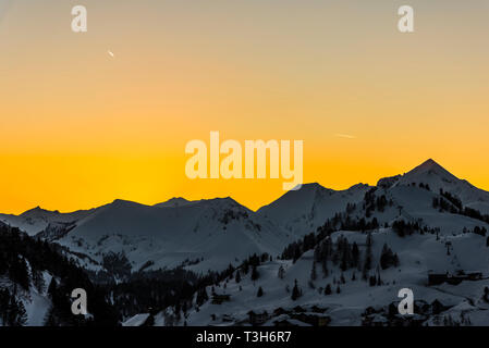 Gelb Himmel bei Sonnenuntergang über den Bergen in Obertauern, Österreich Stockfoto