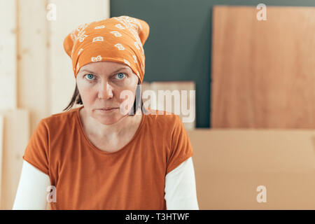 Selbständige Frau Zimmermann von der Kamera Porträt suchen in ihrem kleinen Geschäft Holzarbeiten workshop Stockfoto