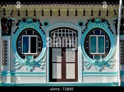 Vorderansicht des traditionellen vintage Peranakan oder Straits Chinesisch Singapur shop Haus mit verzierter Fassade, einzigartige ovale Fenster in historischen Little India Stockfoto