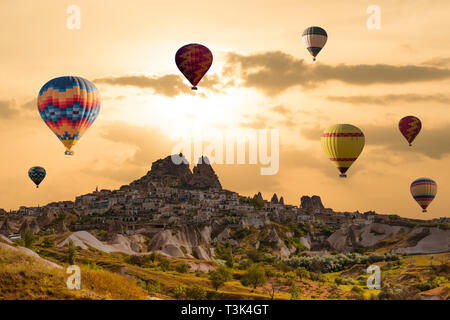 Bunte Heißluftballons fliegen über das Tal in Kappadokien, Uchisar, Türkei. Vulkanberge in Goreme National park Stockfoto