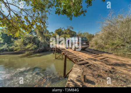 Touristen mit dem Auto Panne auf einer großen, klapprige Holzbrücke mitten in der Wildnis von Paraguay. Stockfoto