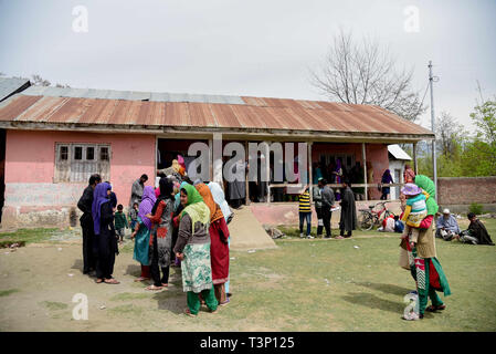 Baramulla, Jammu und Kaschmir, Indien. 11 Apr, 2019. Kaschmir Wähler gesehen in Warteschlangen stehend ihre Stimmen vor dem Wahllokal an Shadipora zu werfen. Stimmen für zwei Sitze im indischen Kaschmir unter fester Sicherheit und ein boykottaufruf von Separatisten begann. Bewaffnete Polizei und paramilitärischen Soldaten in Aufruhr Zahnräder bewacht die Wahllokale und Straßen in der Nähe an. Kredit Idrees: Abbas/SOPA Images/ZUMA Draht/Alamy leben Nachrichten Stockfoto