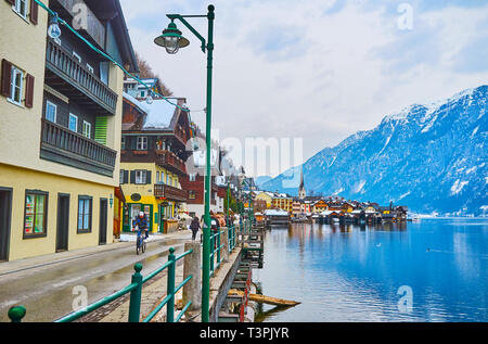 HALLSTATT, Österreich - 21. FEBRUAR 2019: Die seestrasse ist die Uferpromenade und Zentrum der touristischen Aktivität in der Stadt, die Leute hier gehen, genießen Hallstat Stockfoto