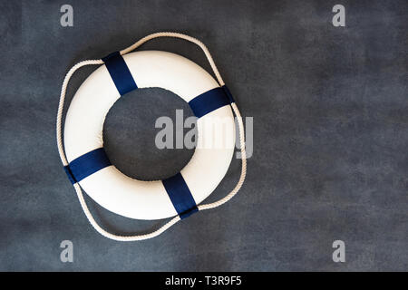 Small marine lifebuoy on a dark background. Stockfoto