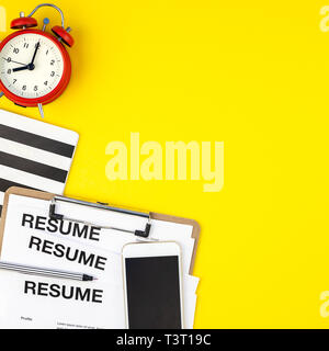 Kreative, oben flach auf dem Schreibtisch mit Resume Dokumente Platz auf kräftigen gelben Hintergrund im minimalistischen Stil kopieren. Konzept der neuen Job, Einstellung Einstellung Stockfoto