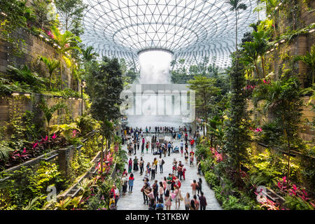 Blick auf die Landschaft des Regenwirbels, der Wasserdampf ausströmt, am Jewel Changi Airport, voll mit Menschen, um das Grün zu sehen. Singapur Stockfoto