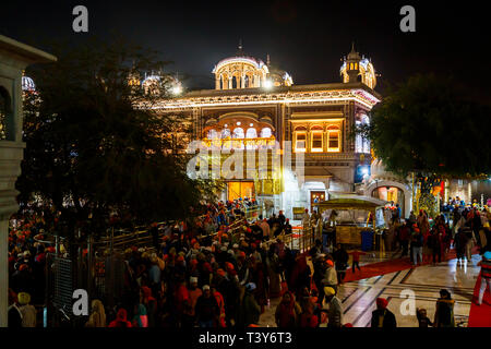 Lokale Sikhs Queuing auf dem Damm der Sanctum Sanctorum der Goldenen Tempel von Amritsar, dem heiligsten Wallfahrtsort des Sikhismus, Punjab eingeben Stockfoto