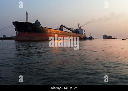 Port Operations für den Transport von Eisenerz in der Dämmerung und Sunrise mit 2 TSV Schiffe - eine an Laden Jetty, ein Warten auf Dock. Sierra Leone Stockfoto