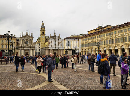 Turin, Piemont, Italien. April 2019. Auf der Piazza San Carlo Menschen versammelt, um für eine Veranstaltung, im Hintergrund die beiden Kirchen, dass der Ort charakterisieren Stockfoto