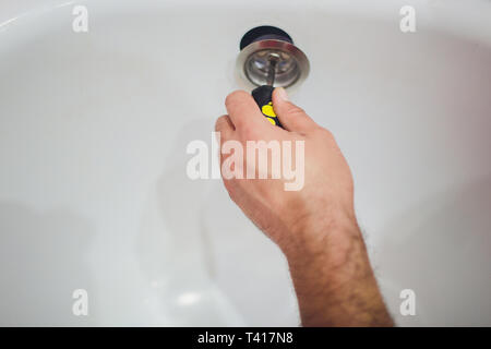Ein klempner Behebt einen Wasseranschluß an einer Wasserleitung. Pepair sanitär Hintergrund. Stockfoto