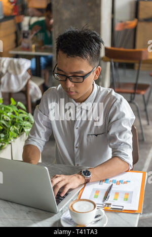 Asiatische freelancer Arbeiten am Laptop im Cafe Stockfoto