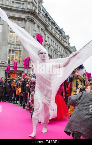 London, Großbritannien. 12. April 2019. Klima Aktivisten vor dem Aussterben Rebellion über Oxford Circus, dem Herzen des Londoner Einkaufsviertel, einen Laufsteg zu Host durch nachhaltige Mode Marken und Kunst und Mode Schüler die Aufmerksamkeit auf die Auswirkungen der nicht nachhaltige Art und Weise zu zeichnen und als Teil einer Protestbewegung, die Regierung auf, dringend Maßnahmen zu ergreifen, um den Klimawandel zu bekämpfen. Credit: Mark Kerrison/Alamy Live News Credit: Mark Kerrison/Alamy leben Nachrichten Stockfoto